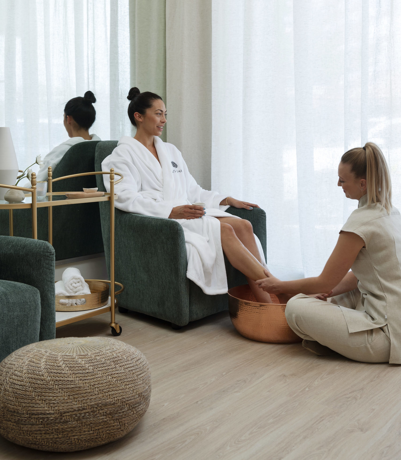A woman receives a foot scrub by BODHI employee